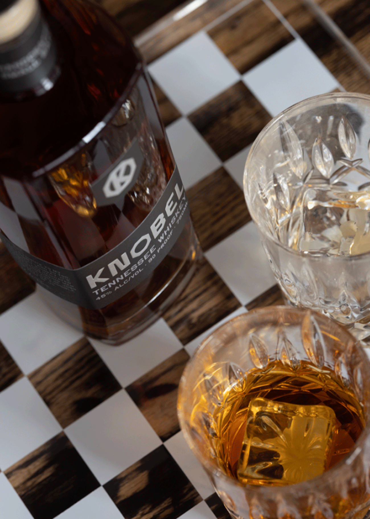 Knobel Tennessee Whiskey Bottle next to 2 glasses with ice
